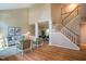 Spacious living room with hardwood floors, staircase and tall windows at 103 Windhover Dr, Chapel Hill, NC 27514