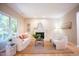 Bright living room features a fireplace, neutral walls, hardwood floors, a jute rug and comfortable seating at 103 Windhover Dr, Chapel Hill, NC 27514