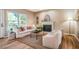 Comfortable living room boasts a fireplace, large windows, light walls, and stylish decor and furniture at 103 Windhover Dr, Chapel Hill, NC 27514