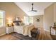 Cozy main bedroom featuring hardwood floors, a ceiling fan, and ample natural light from multiple windows at 103 Windhover Dr, Chapel Hill, NC 27514