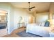 Bright main bedroom with hardwood floors, a ceiling fan, and ample natural light from windows, and an ensuite bathroom at 103 Windhover Dr, Chapel Hill, NC 27514
