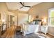 Spacious main bedroom with hardwood floors, a ceiling fan, and natural light, offering a relaxing retreat at 103 Windhover Dr, Chapel Hill, NC 27514