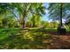 Outdoor picnic area with several picnic tables, a grill, and a play area amidst mature trees and green grass at 103 Windhover Dr, Chapel Hill, NC 27514