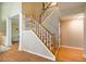 Beautiful foyer with wooden staircase showcasing white railings and views of hardwood floors at 103 Windhover Dr, Chapel Hill, NC 27514