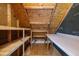 A spacious attic with wood beam architecture includes built-in shelving, perfect for storage at 104 Dallavia Ct, Morrisville, NC 27560