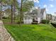 Lush backyard with a gazebo, deck, mature trees, and a rock drainage feature at 104 Dallavia Ct, Morrisville, NC 27560