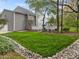 A lush green backyard showcases a deck, gazebo, and a decorative rock drainage feature at 104 Dallavia Ct, Morrisville, NC 27560