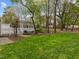 A large, green backyard featuring a gazebo and deck, framed by mature trees at 104 Dallavia Ct, Morrisville, NC 27560