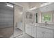 Bathroom with double vanity, granite counters, mirror, and walk-in closet at 104 Dallavia Ct, Morrisville, NC 27560