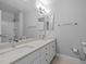 Bathroom featuring a double vanity, large mirror, and updated fixtures at 104 Dallavia Ct, Morrisville, NC 27560