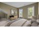 Bedroom with soft colors, bedside table, and large windows at 104 Dallavia Ct, Morrisville, NC 27560