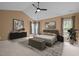 Well-lit primary bedroom with a decorative tray ceiling, dual windows, and stylish furniture at 104 Dallavia Ct, Morrisville, NC 27560