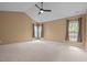 Spacious bedroom featuring vaulted ceilings and ample natural light from multiple windows at 104 Dallavia Ct, Morrisville, NC 27560