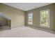 Bedroom with carpeted floor and natural light streaming in from large windows at 104 Dallavia Ct, Morrisville, NC 27560