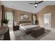 Staged bedroom with neutral tones, ceiling fan, and view of bathroom at 104 Dallavia Ct, Morrisville, NC 27560