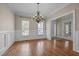 An empty dining room with chair railing and hardwood flooring and a chandelier at 104 Dallavia Ct, Morrisville, NC 27560