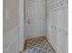 Entryway area with gray patterned rug, hooks and wainscoting on the wall and a white door at 104 Dallavia Ct, Morrisville, NC 27560