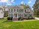 Charming two-story home with traditional architecture, complemented by a manicured lawn and inviting curb appeal at 104 Dallavia Ct, Morrisville, NC 27560