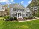 Charming gray home with manicured landscaping, brick steps and black shutters at 104 Dallavia Ct, Morrisville, NC 27560