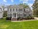 Charming gray home with manicured landscaping, brick steps and black shutters at 104 Dallavia Ct, Morrisville, NC 27560