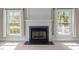 Living room featuring a fireplace, bright windows and neutral finishes at 104 Dallavia Ct, Morrisville, NC 27560