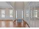Inviting foyer with hardwood floors, transom windows, and a view into adjacent rooms at 104 Dallavia Ct, Morrisville, NC 27560