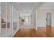 Spacious foyer showcasing hardwood floors leading to a carpeted staircase and views into other rooms at 104 Dallavia Ct, Morrisville, NC 27560