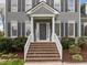 A stately home featuring a brick staircase and white pillars at the entrance at 104 Dallavia Ct, Morrisville, NC 27560