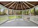 The gazebo offers an excellent backyard view with a decorative ceiling fan at 104 Dallavia Ct, Morrisville, NC 27560