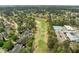 Aerial shot showcases a golf course winding through a residential area and a fitness center at 104 Dallavia Ct, Morrisville, NC 27560