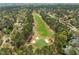 Aerial view of a lush green golf course surrounded by tree-lined fairways and residential homes at 104 Dallavia Ct, Morrisville, NC 27560