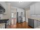 Well-lit kitchen features stainless steel appliances, white cabinets and granite countertops at 104 Dallavia Ct, Morrisville, NC 27560