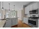 Open concept kitchen with stainless steel appliances, white cabinets, and granite countertops at 104 Dallavia Ct, Morrisville, NC 27560