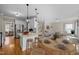 Open-concept kitchen and living area, stainless appliances, eat-in kitchen island and wood floors at 104 Dallavia Ct, Morrisville, NC 27560