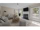 Living room featuring a fireplace, bright windows and neutral finishes at 104 Dallavia Ct, Morrisville, NC 27560