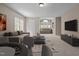 Bright living room offering comfortable seating, a modern entertainment center, and natural light at 104 Dallavia Ct, Morrisville, NC 27560