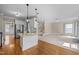 Open-concept living room features stainless steel appliances and a granite-topped kitchen island at 104 Dallavia Ct, Morrisville, NC 27560