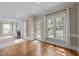 Bright living room boasts wood floors, a fireplace, and a sunroom with gazebo views at 104 Dallavia Ct, Morrisville, NC 27560