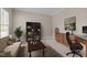 Office featuring built-in bookcases, desk space, and a cozy seating area at 104 Dallavia Ct, Morrisville, NC 27560