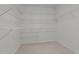 Large walk-in closet with carpeted floors and extensive shelving at 104 Dallavia Ct, Morrisville, NC 27560