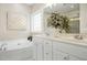 Bright bathroom featuring a soaking tub, double vanity, and a neutral color scheme at 109 Homegate Cir, Apex, NC 27502