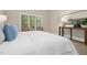 Bedroom with a cozy bed, side table, and a view of the outdoor foliage at 109 Homegate Cir, Apex, NC 27502