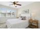 Bedroom with white bedding, neutral walls, carpet floors, and natural light from a large window at 109 Homegate Cir, Apex, NC 27502