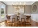 Elegant dining room featuring modern lighting, hardwood floors, and neutral decor at 109 Homegate Cir, Apex, NC 27502