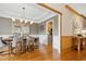 Elegant dining room featuring modern lighting, hardwood floors, neutral decor, open floor plan at 109 Homegate Cir, Apex, NC 27502