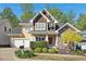 Charming two-story home featuring a stone facade, cedar shingles, and a well-manicured front yard at 109 Homegate Cir, Apex, NC 27502