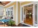 Inviting covered front porch featuring a red front door, bench seating, and decorative foliage, interior view at 109 Homegate Cir, Apex, NC 27502