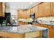 Bright kitchen featuring granite countertops, stainless steel appliances, and wooden cabinetry at 109 Homegate Cir, Apex, NC 27502