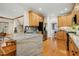 Spacious kitchen showcasing granite island with seating and hardwood floors at 109 Homegate Cir, Apex, NC 27502