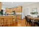 Well-lit kitchen featuring granite countertops, wooden cabinetry, and a breakfast bar at 109 Homegate Cir, Apex, NC 27502